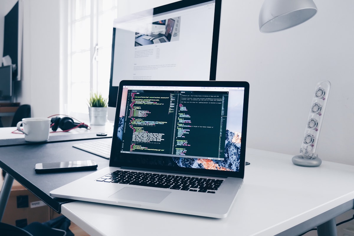 Home office workspace with laptop and coffee on desk